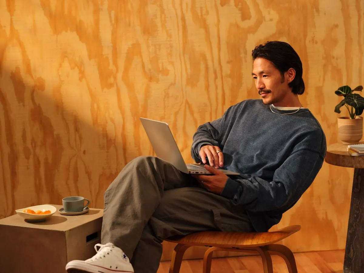 A person focused on work at a laptop